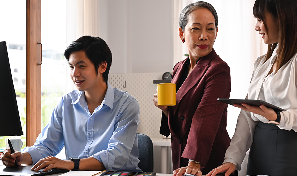 3 professionals collaborating at a computer in an office | Admin Outsourcing | Parallel Outsourcing