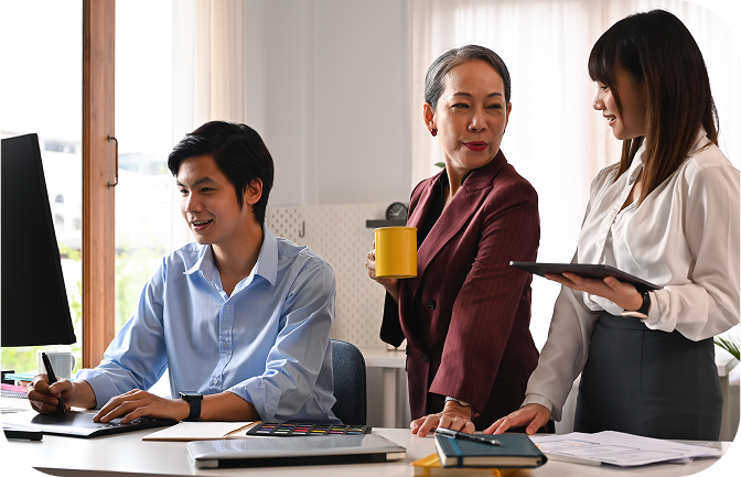 Three colleagues discussing work in an office setting | Admin Outsourcing | Parallel Outsourcing