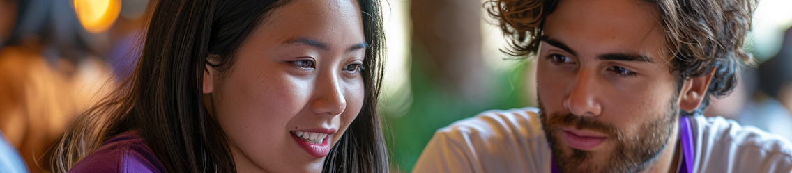 Two young adults look attentively at something | Admin Outsourcing | Parallel Outsourcing