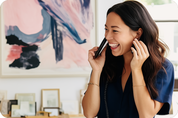 Smiling woman talking on the phone in a modern office | Offshore Outsourcing | Parallel Outsourcing