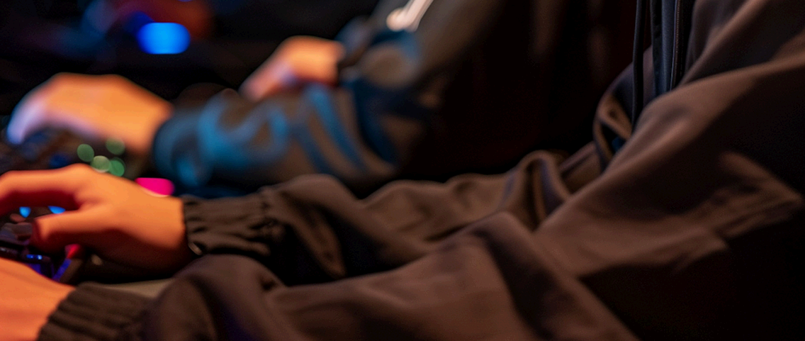 Close-up of hands gaming in a dark room | It Outsourcing | Parallel Outsourcing