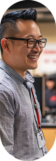 Smiling man in glasses at a desk in an office | Offshore Outsourcing | Parallel Outsourcing