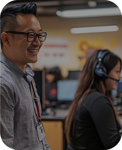 Smiling man in glasses at a desk in an office | Customer Service Outsourcing | Parallel Outsourcing