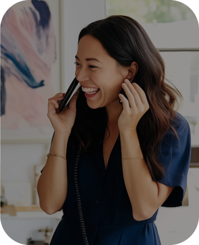Smiling woman in blue, talking on a phone | Outsource Accounting Services | Parallel Outsourcing